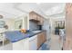 Well-equipped kitchen showcasing wood cabinets, blue countertops, and an adjacent dining area for easy entertaining at 2955 N Beach Rd # D113, Englewood, FL 34223