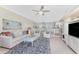 Open living space with water view featuring comfortable furniture, a ceiling fan, and seamless kitchen access at 2955 N Beach Rd # D113, Englewood, FL 34223