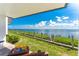 Patio area has green space along the water for relaxing at 2955 N Beach Rd # D113, Englewood, FL 34223