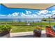 Relaxing patio area with views of the water and lush landscaping at 2955 N Beach Rd # D113, Englewood, FL 34223