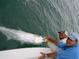 Two men holding a large tarpon fish on a boat, perfect for fishing enthusiasts at 2955 N Beach Rd # D113, Englewood, FL 34223
