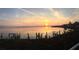 Stunning waterfront view at sunset, complete with private docks and beautiful landscaping at 2955 N Beach Rd # D113, Englewood, FL 34223