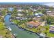 Drone shot of the neighborhood highlighting the canal-front property and the surrounding houses at 30 Buccaneer Bnd, Placida, FL 33946
