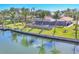 The home's backyard features a waterfront view, a screened lanai, and lush landscaping at 30 Buccaneer Bnd, Placida, FL 33946