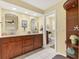 Bathroom features double sink with granite counters, wooden cabinets, and toilet room at 30 Buccaneer Bnd, Placida, FL 33946