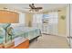 Bedroom with tile floors, decorated surfboard, white curtains, and tropical ceiling fan at 30 Buccaneer Bnd, Placida, FL 33946
