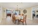 Open dining room leading to the kitchen, featuring a chandelier and backyard views at 30 Buccaneer Bnd, Placida, FL 33946