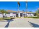 Attractive single-story home with a gravel driveway, palm trees, and a welcoming entrance at 30 Buccaneer Bnd, Placida, FL 33946