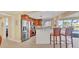 Bright kitchen with stainless steel appliances, counter seating, and a view of the backyard pool at 30 Buccaneer Bnd, Placida, FL 33946
