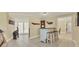 Open-concept living space featuring a built-in bar with seating, tile floors, and access to outdoor areas at 30 Buccaneer Bnd, Placida, FL 33946