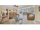 Spacious living room showcases a comfortable seating arrangement, tile floors, and access to the lanai at 30 Buccaneer Bnd, Placida, FL 33946