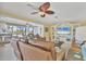 Inviting living room featuring tile flooring, comfortable furniture, and a view of the pool area at 30 Buccaneer Bnd, Placida, FL 33946