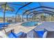 Relaxing screened in-ground pool area, surrounded by lush landscaping and canal at 30 Buccaneer Bnd, Placida, FL 33946