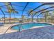 Inviting in-ground pool under screened lanai, with lush landscaping and water views at 30 Buccaneer Bnd, Placida, FL 33946