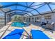 Enclosed pool area featuring a kidney shaped pool, brick pavers, and lounge chairs with a view of the water at 30 Buccaneer Bnd, Placida, FL 33946