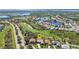Aerial view of a residential neighborhood with houses surrounding a golf course and lakes at 3511 Bay Ridge Way, Port Charlotte, FL 33953