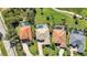 A bird's eye view showcasing meticulously landscaped yards, private pools, and the manicured green of a golf course at 3511 Bay Ridge Way, Port Charlotte, FL 33953