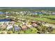 Aerial view of a neighborhood showcasing well-maintained homes, lush landscaping, and a golf course at 3511 Bay Ridge Way, Port Charlotte, FL 33953