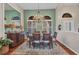 Dining room with a chandelier, hardwood floors, area rug and windows with shutters at 3511 Bay Ridge Way, Port Charlotte, FL 33953