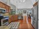 Open-concept kitchen with stainless steel appliances, granite counters, and easy access to living room, great for entertaining at 3511 Bay Ridge Way, Port Charlotte, FL 33953