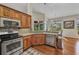 Attractive kitchen featuring granite countertops, stainless steel appliances, and views of the beautiful surrounding landscape at 3511 Bay Ridge Way, Port Charlotte, FL 33953