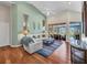 Bright living room with vaulted ceilings, hardwood floors, and sliding doors to the pool area at 3511 Bay Ridge Way, Port Charlotte, FL 33953