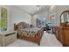 Spacious main bedroom with work space, sliding glass doors, and dresser at 3511 Bay Ridge Way, Port Charlotte, FL 33953