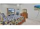 Main bedroom with sliding glass doors to pool, work space, and wood dresser at 3511 Bay Ridge Way, Port Charlotte, FL 33953