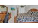 Main bedroom with patterned bedding, dresser, work space, and sliding glass door at 3511 Bay Ridge Way, Port Charlotte, FL 33953