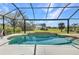 Enjoy outdoor living with this screened-in pool, offering a relaxing oasis with a view of the beautiful green landscape at 3511 Bay Ridge Way, Port Charlotte, FL 33953