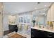 Bright bathroom with double vanity, marble walls, and a large mirror enhancing the space at 44 Waterford Dr, Englewood, FL 34223