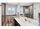 Modern bathroom featuring stylish tile, a glass shower, and a sleek vanity at 44 Waterford Dr, Englewood, FL 34223
