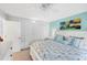 Comfortable bedroom with a ceiling fan, large closet, and serene blue accent wall at 44 Waterford Dr, Englewood, FL 34223
