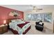 Cozy bedroom with a bay window, ceiling fan, and comfortable seating area at 44 Waterford Dr, Englewood, FL 34223