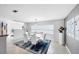 Modern dining room with glass table, white chairs, and contemporary artwork, offering a stylish space for meals at 44 Waterford Dr, Englewood, FL 34223