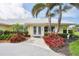 Charming home featuring a well-manicured lawn, lush landscaping, and a welcoming front entrance at 44 Waterford Dr, Englewood, FL 34223
