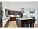 Beautiful kitchen with sleek cabinetry, stainless steel appliances, light countertops, and a large island with bar stools at 44 Waterford Dr, Englewood, FL 34223