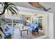 Inviting lanai with comfortable seating, a ceiling fan, and waterfront views at 44 Waterford Dr, Englewood, FL 34223