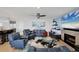 Cozy living room featuring blue sofas, a fireplace, and modern decor in a bright setting at 44 Waterford Dr, Englewood, FL 34223