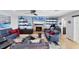 Inviting living room with blue walls, comfortable sofas, and a decorative fireplace with a tv above at 44 Waterford Dr, Englewood, FL 34223