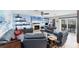 Bright living room with comfortable seating, a stone fireplace, and stylish decor at 44 Waterford Dr, Englewood, FL 34223