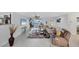 Open living room with stylish furnishings, tile flooring, and access to outdoor patio, creating a relaxed atmosphere at 44 Waterford Dr, Englewood, FL 34223