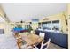 Large patio with an outdoor kitchen, dining area and comfortable seating for relaxing and entertaining at 44 Waterford Dr, Englewood, FL 34223