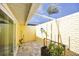 Cozy outdoor patio space with brick walls, plants, and a covered ceiling at 44 Waterford Dr, Englewood, FL 34223