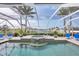 Beautiful pool and spa surrounded by lush landscaping with amazing views of the bay at 44 Waterford Dr, Englewood, FL 34223