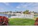 Scenic waterfront with a private dock and lush landscaping, offering direct access to the water at 44 Waterford Dr, Englewood, FL 34223