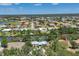Scenic aerial view of a waterfront home nestled in a lush community with golf course and canals at 4624 Pompano St, Placida, FL 33946