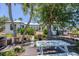 Beautiful backyard with a white picnic table, lush landscaping, and views of the home's architecture at 4624 Pompano St, Placida, FL 33946