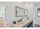 Bright bathroom with double vanity and decorative mirror at 4624 Pompano St, Placida, FL 33946