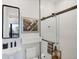 Modern bathroom featuring a glass enclosed shower with striking black hardware and fixtures at 4624 Pompano St, Placida, FL 33946